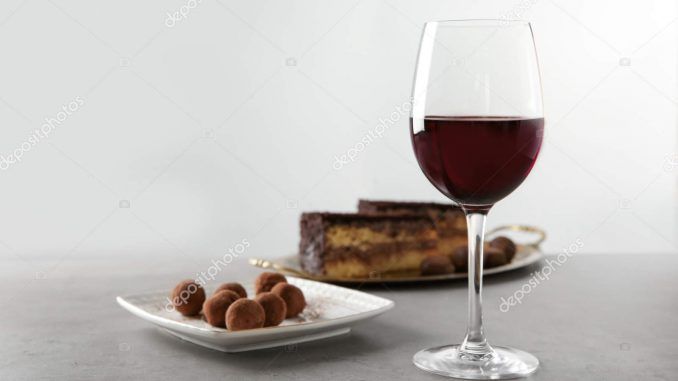 Red wine and chocolate dessert on grey table